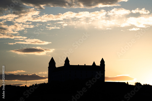 Photography Warm sunset silhouette shot of Bratislava Castle with clouds above, Slovakia, Ea