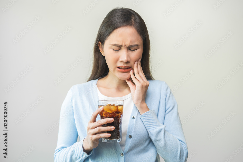 Health asian young woman touching her mouth, expression, suffering from toothache, decay or sensitivity cavity molar tooth or inflammation drink cold, sparkling water at home. Sensitive teeth people Health asian young woman touching her mouth, expression, suffering from toothache, decay or sensitivity cavity molar tooth or inflammation drink cold, sparkling water at home. Sensitive teeth people