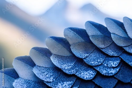 Close-up of vibrant blue bird feathers, intricate texture, blurred mountain backdrop. photo