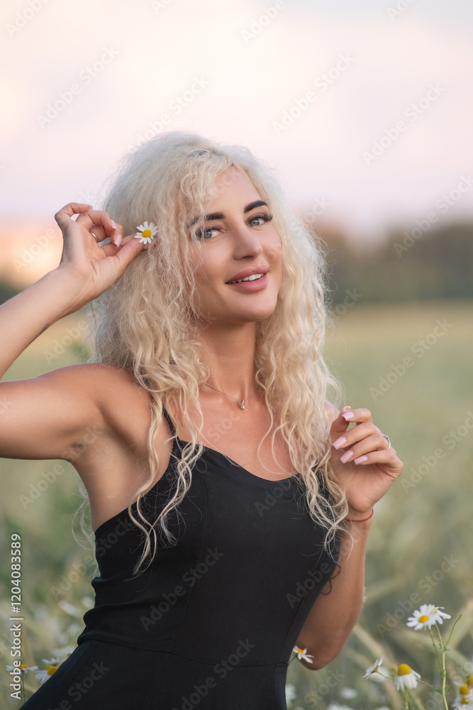 Naklejka premium Portrait of a young beautiful blonde girl in nature in summer.