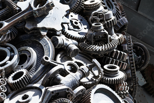 Metal gears background. Old and rusty spare parts for industrial machines in a landfill..