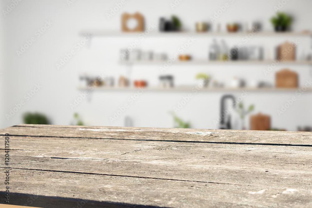Fototapeta premium Rustic wooden table top in a bright kitchen setting. Ideal for product displays or food photography.