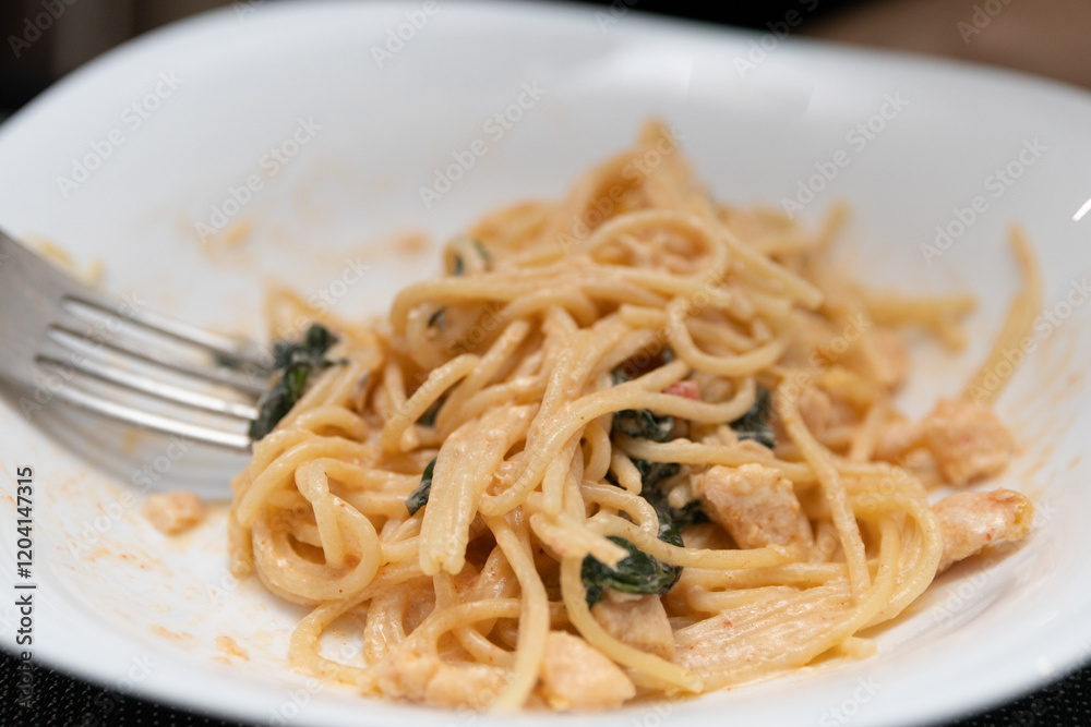 Delicious Italian pasta in a white plate on the table Delicious Italian pasta in a white plate on the table
