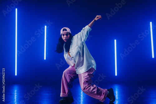 Hip hop dancer dancing in a cool studio with neon lights.