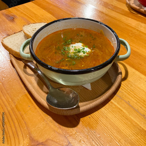 Delights of Kapustnica (sauerkraut soup), classic Slovak winter national meal features tangy sauerkraut and a mix of meats like pork and sausage, dried mushrooms, onions, garlic and paprika photo