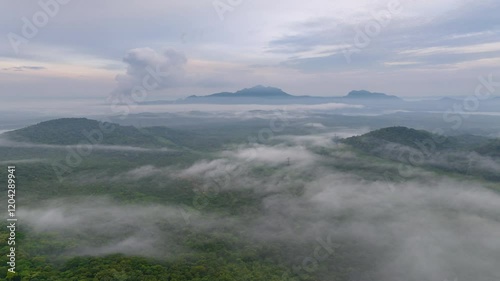 4K Hyperlapse Video: Morning Aerial View, Fog Flowing Over Tall Mountains, Fog or Clouds Moving, Steam Emitted From Metal Pipes of Coal-Fired Power Plant in the Background.
