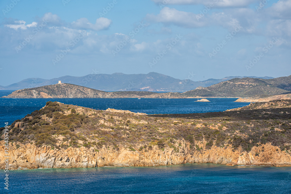 Landscape of the south-west coast of Sardinia with cliffs, blue sea, fjords and white clouds Landscape of the south-west coast of Sardinia with cliffs, blue sea, fjords and white clouds