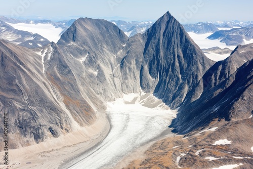 High-altitude view of Greenland's rugged mountains and glaciers under a soft sky photo