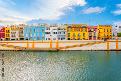 Colorful facades of traditional Spanish buildings face the Guadalquivir River in the Triana District of the Analusian city of Seville, Spain.	