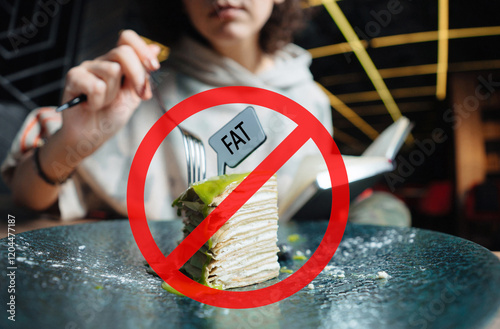 Slice of cake on plate with red prohibition sign symbolizing fat-free or low-fat diet concept photo