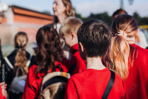 Tableau sur toile Group of school pupils and students on outdoor excursion tour in the city street