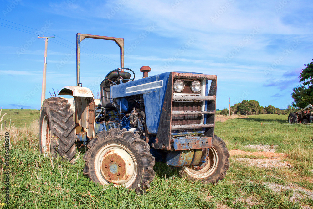 Dark blue agricultural tractor outside on the farm in a rural area. Dark blue agricultural tractor outside on the farm in a rural area.