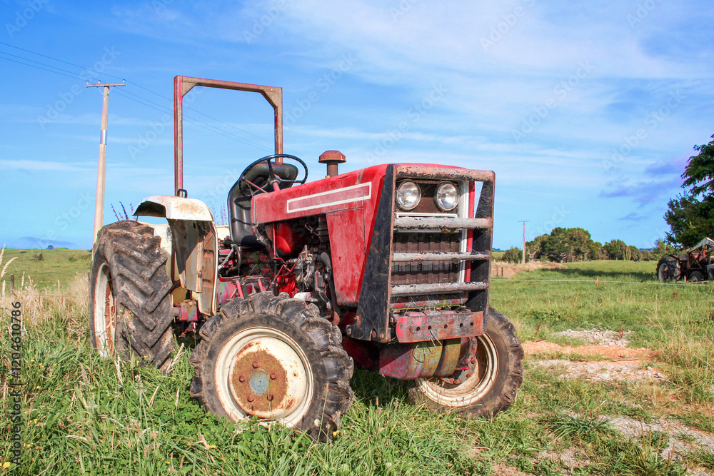 Red agricultural tractor outside on the farm in a rural area. Red agricultural tractor outside on the farm in a rural area.