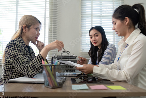 Business team discussing and analyzing data in a collaborative office environment photo