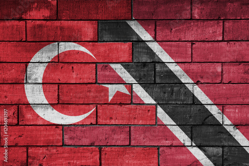 colourful painted big flag of turkey and flag of trinidad and tobago on a massive old brick wall background. concept photo