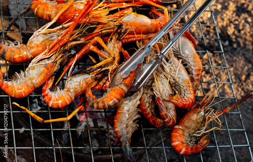 River prawns on a grill. Popular seafood dishes: Grilled prawns. Fresh prawns, grilled or roasted over a fire.