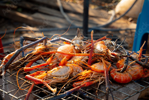 River prawns on a grill. Popular seafood dishes: Grilled prawns. Fresh prawns, grilled or roasted over a fire.