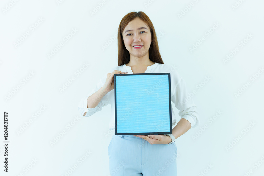 Asian woman showing the new carbon air purifier filter to camera close up. HEPA filter used in high efficiency air purifier system to purify the dirty or polluted air inside the house or vehicle. Asian woman showing the new carbon air purifier filter to camera close up. HEPA filter used in high efficiency air purifier system to purify the dirty or polluted air inside the house or vehicle.