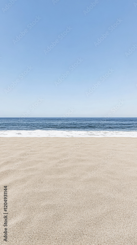 Fototapeta premium Peaceful sandy beach under a clear blue sky near the calm ocean waves