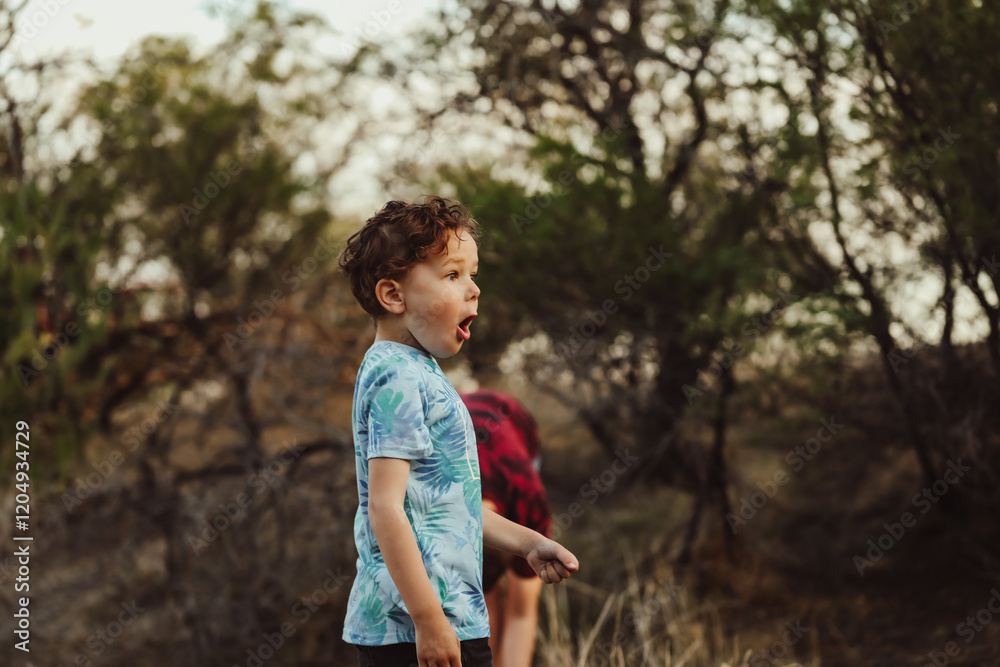 Little boy exploring nature with surprised expression Little boy exploring nature with surprised expression
