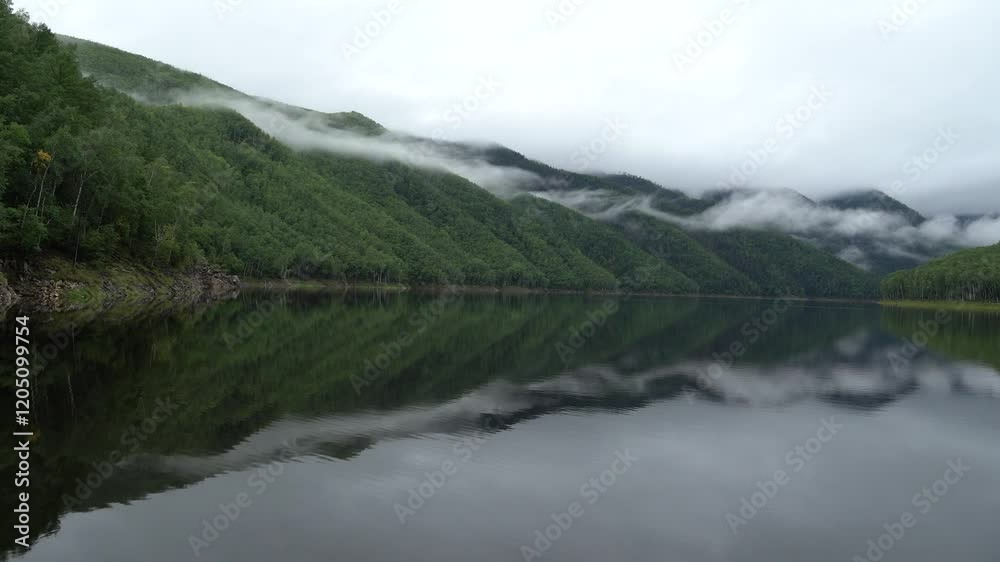 View from a boat. A boat jets along a picturesque lake in the Zeisky Nature Reserve. Far Eastern taiga. View from a boat. A boat jets along a picturesque lake in the Zeisky Nature Reserve. Far Eastern taiga.