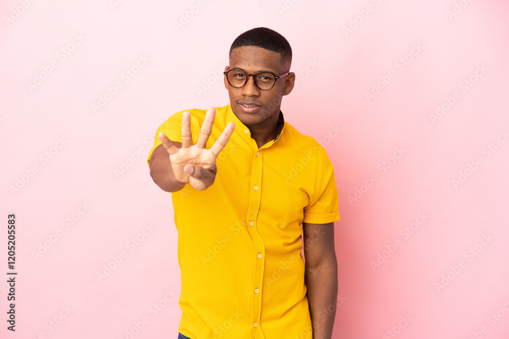 Young latin man isolated on pink background happy and counting four with fingers Young latin man isolated on pink background happy and counting four with fingers