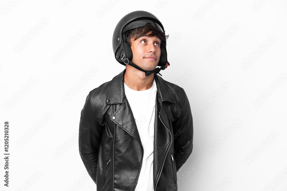 Young man with a motorcycle helmet isolated on white background and looking up Young man with a motorcycle helmet isolated on white background and looking up