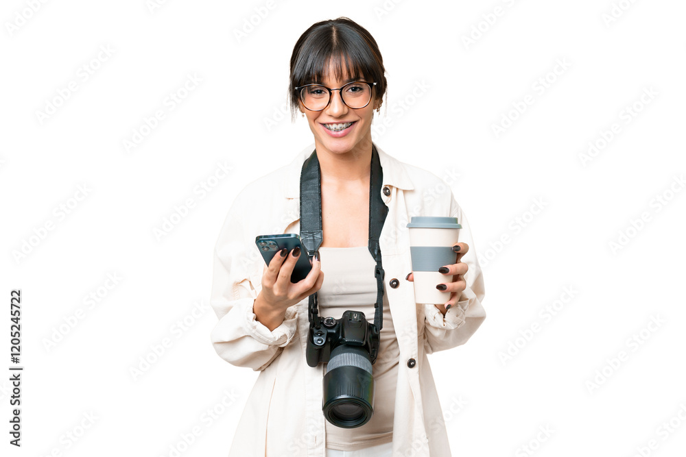 Young photographer caucasian woman over isolated chroma key background holding coffee to take away and a mobile Young photographer caucasian woman over isolated chroma key background holding coffee to take away and a mobile