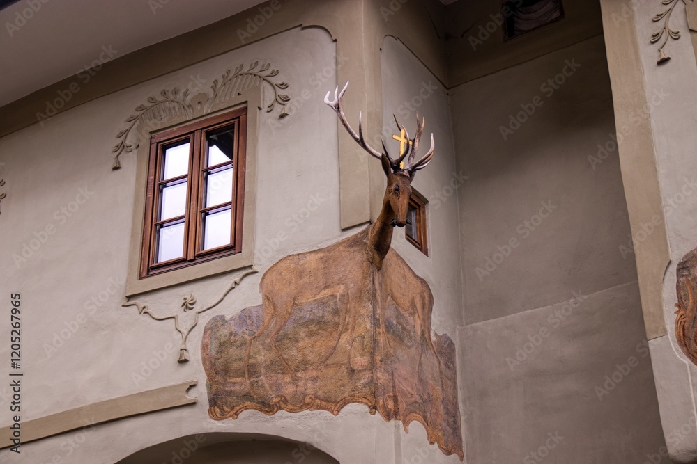 A head of the deer at the corner of the house at Vimperk, Czech republic