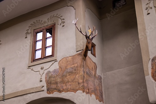 Obraz na płótnie A head of the deer at the corner of the house at Vimperk, Czech republic w salonie