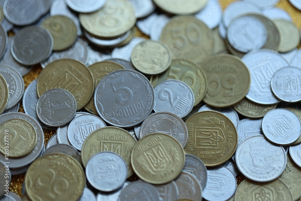 Metal coins of Ukraine of different denominations are scattered. Money texture, business background. Metal coins of Ukraine of different denominations are scattered. Money texture, business background.