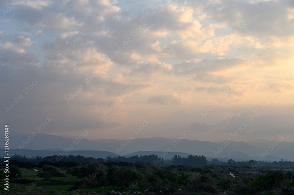 Dramatic clouds gather over rolling hills at sunset in a serene natural landscape Dramatic clouds gather over rolling hills at sunset in a serene natural landscape