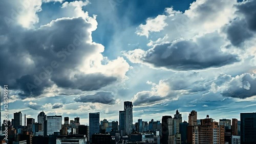 Urban skyline showcasing dramatic cloud formations and sunlight peeking through in Johannesburg's cityscape