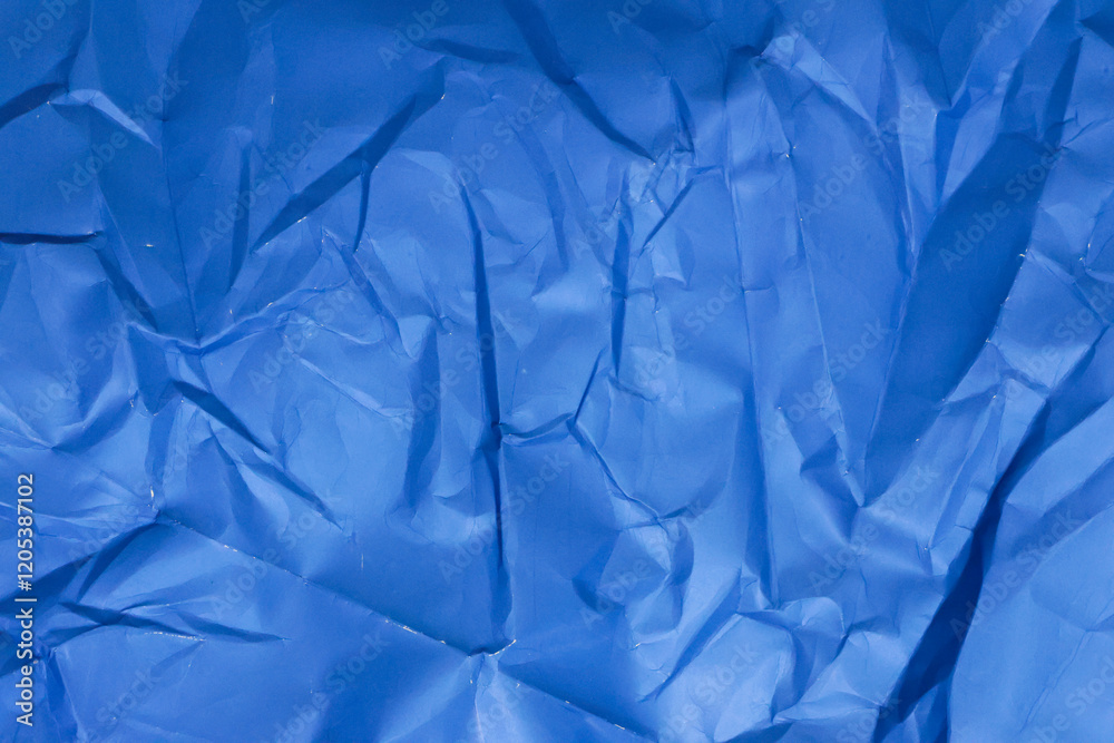 Obraz premium Sheet of crumpled blue paper as background, top view