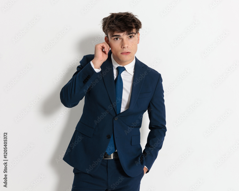 relaxed businessman touching his ear with a gesture relaxed businessman touching his ear with a gesture