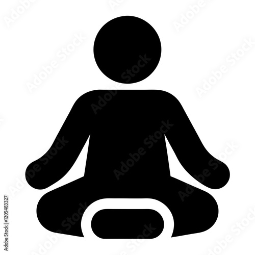 A man is sitting on a cushion. He is holding his hand up. The man is wearing a black shirt