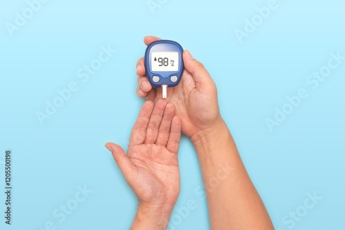 Person holding a blue blood sugar monitor