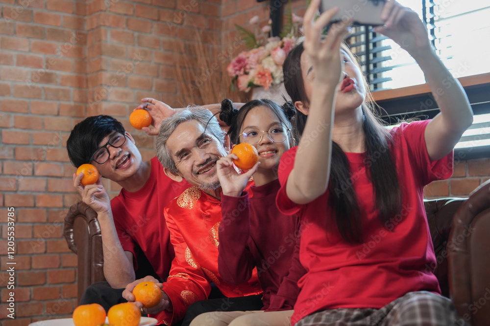 Fototapeta premium happy asian family gathering at home to celebrate Chinese New Year,sitting on couch and enjoy taking selfie