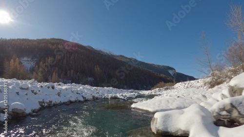 Wallpaper Mural Dynamic aerial drone view following the winding path of a river through a scenic landscape. Perfect for nature, travel, and environmental projects. Torontodigital.ca