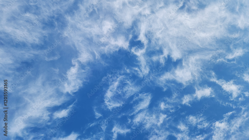 A brilliant blue sky adorned with wispy cirrus clouds creates an enchanting winter backdrop, perfect for a fairytale design. A brilliant blue sky adorned with wispy cirrus clouds creates an enchanting winter backdrop, perfect for a fairytale design.