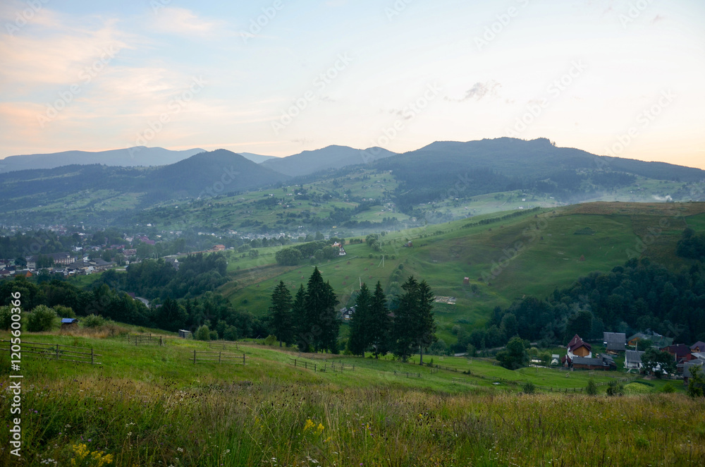 Fototapeta premium Charming small village amid gentle hills and open fields