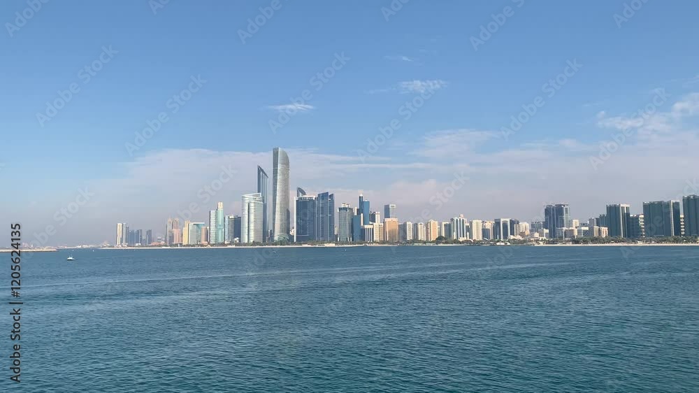 Panoramic, scenic view of Abu Dhabi city skyline and waterfront. Skyscrapers, Al Lulu Island. Motion of Arabian Gulf water waves. Abu Dhabi, United Arab Emirates Panoramic, scenic view of Abu Dhabi city skyline and waterfront. Skyscrapers, Al Lulu Island. Motion of Arabian Gulf water waves. Abu Dhabi, United Arab Emirates