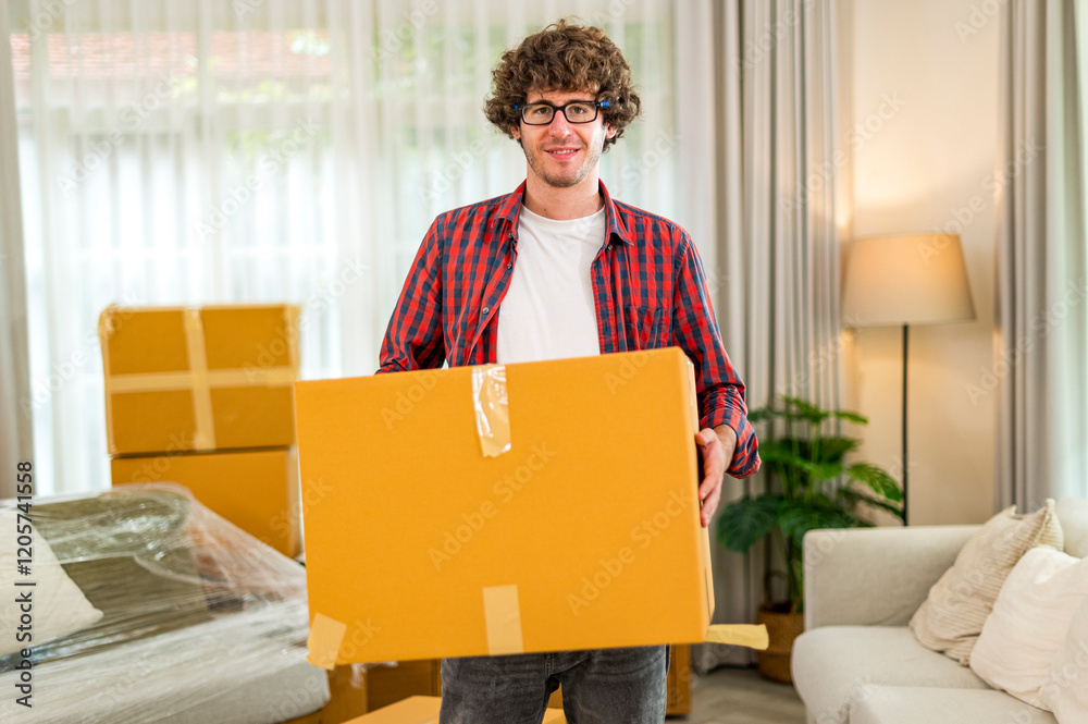 Happy smile young man carrying and load cardboard box at moving into a new house, new apartment, new home - Moving house and Delivery