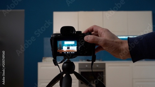 Obraz na płótnie Real estate photographer taking pictures and videos at house in apartment living room with professional camera - selling home with real estate agency and home staging indoor home design w salonie