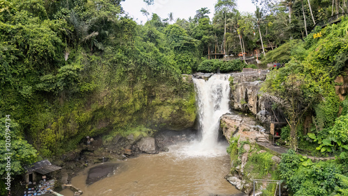 Tegenungan Waterfall, a picturesque Bali attraction, is surrounded by dense jungle and vibrant greenery, offering a tranquil escape and mesmerizing views for nature lovers and adventure seekers. photo