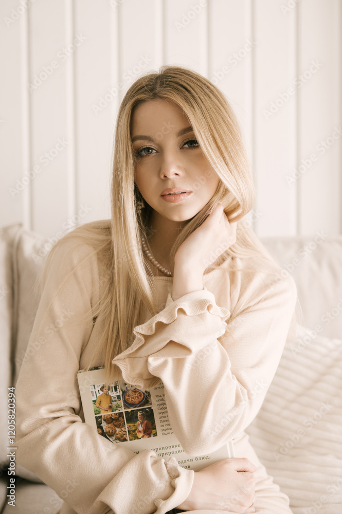 Beautiful blonde woman posing in a beautiful modern stylish beige interior
