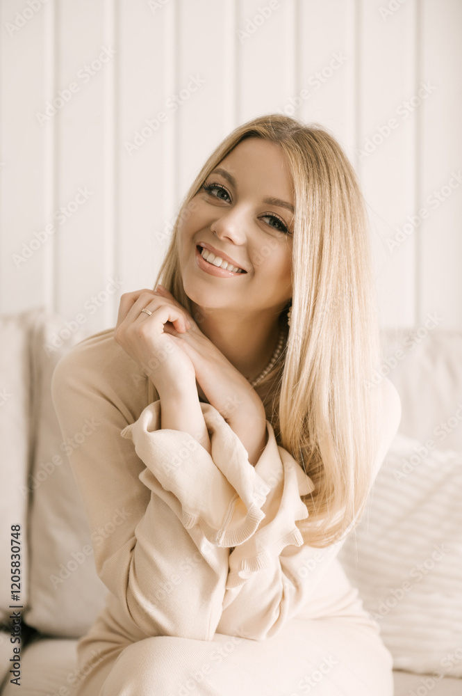 Beautiful blonde woman posing in a beautiful modern stylish beige interior