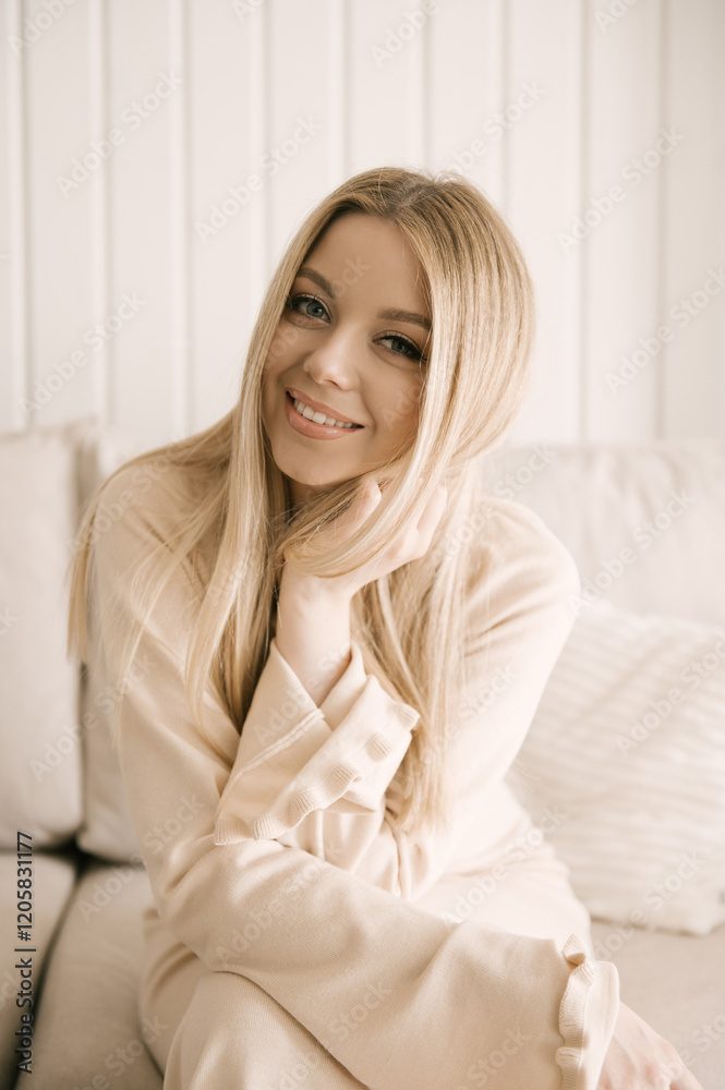 Beautiful blonde woman posing in a beautiful modern stylish beige interior