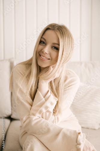 Obraz na płótnie Beautiful blonde woman posing in a beautiful modern stylish beige interior w salonie