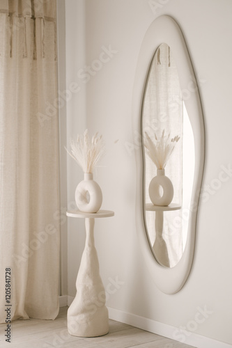 Obraz na płótnie Beautiful light beige interior with curved mirror in wooden frame in japandi and wawabi sabi style, cozy home concept w salonie